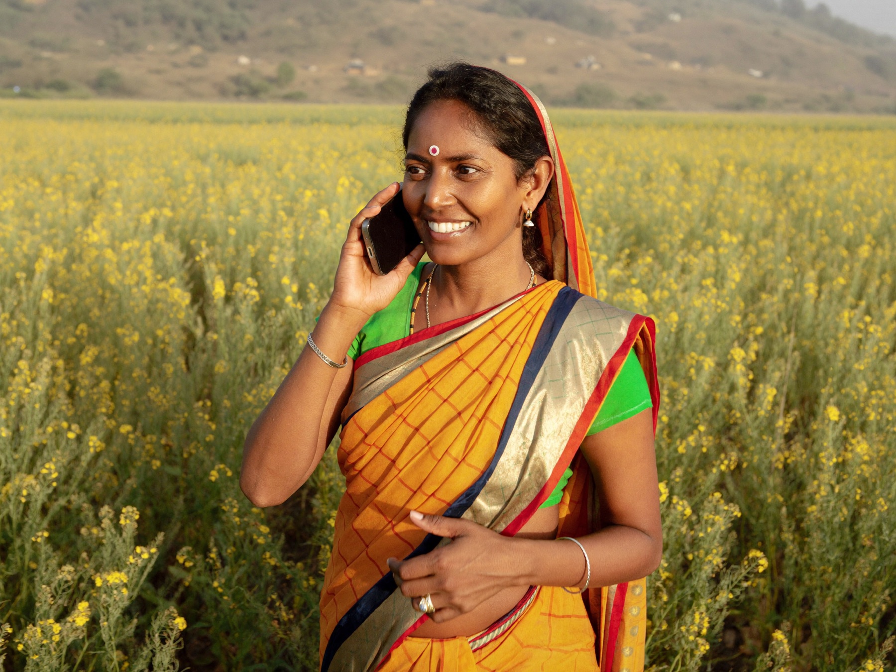 A woman farmer in a mustard field